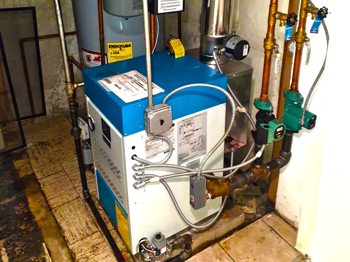 Floor-standing boiler and practical piping in a tidy Queens home basement